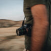 CLC08864 A person holding a camera while in motion on barren landscape