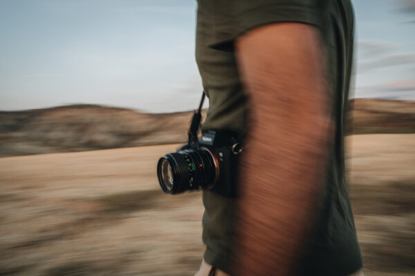 CLC08864 A person holding a camera while in motion on barren landscape