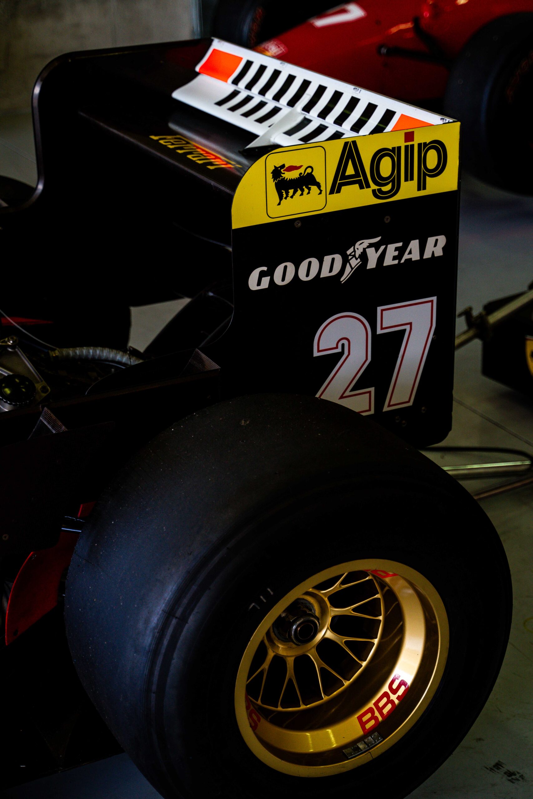 Rear view of a Formula 1 car showcasing “Agip” and “Goodyear” branding on the rear wing and tire