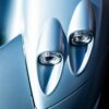 Close-up of dual headlights on a sleek silver sports car, highlighting modern design at The I.C.E. St. Moritz 2023