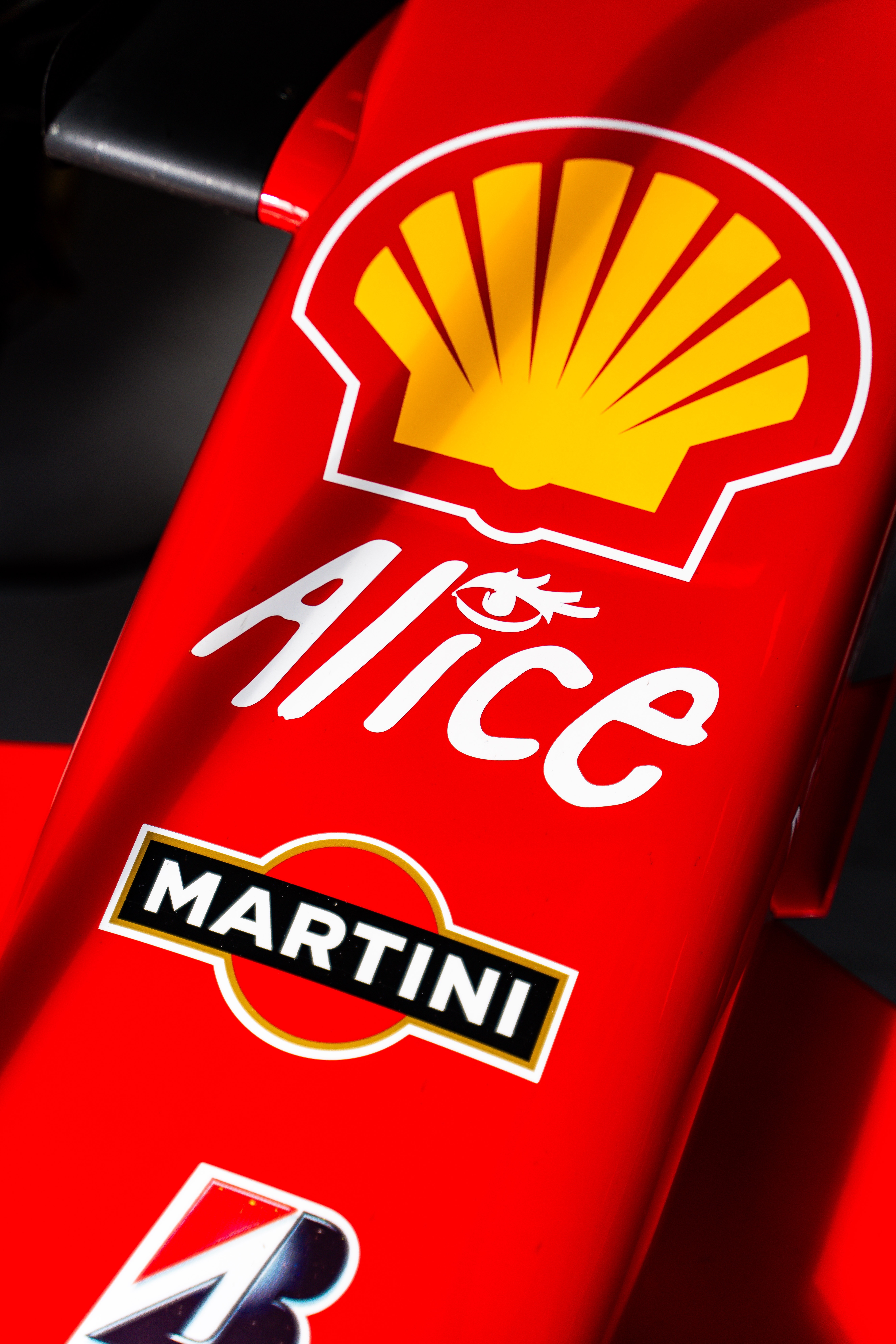 Close-up of Ferrari sponsorship logos, including Shell and Martini, prominently displayed on the car