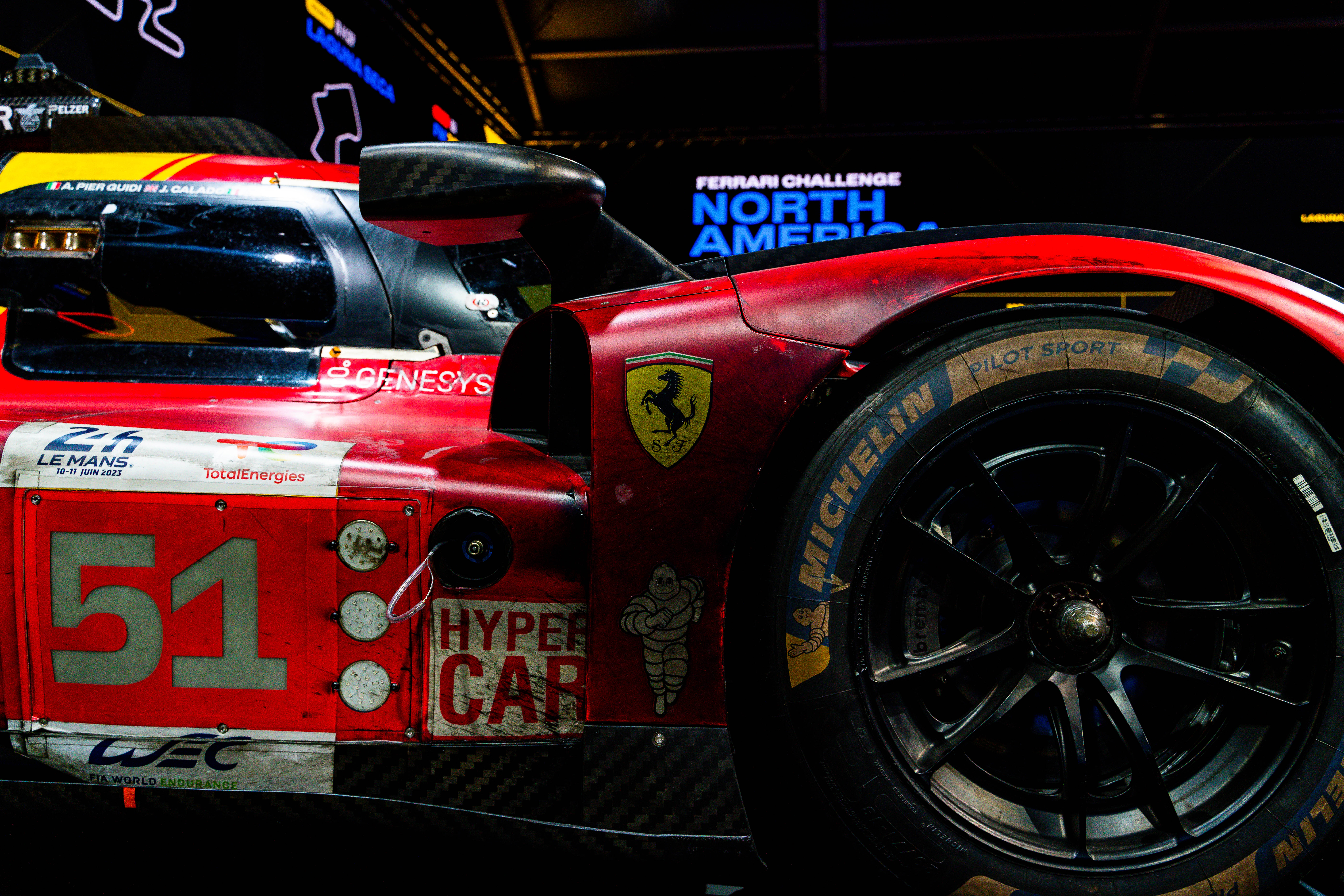 Close-up of the side profile of a Ferrari endurance race car with detailed sponsor logos and markings