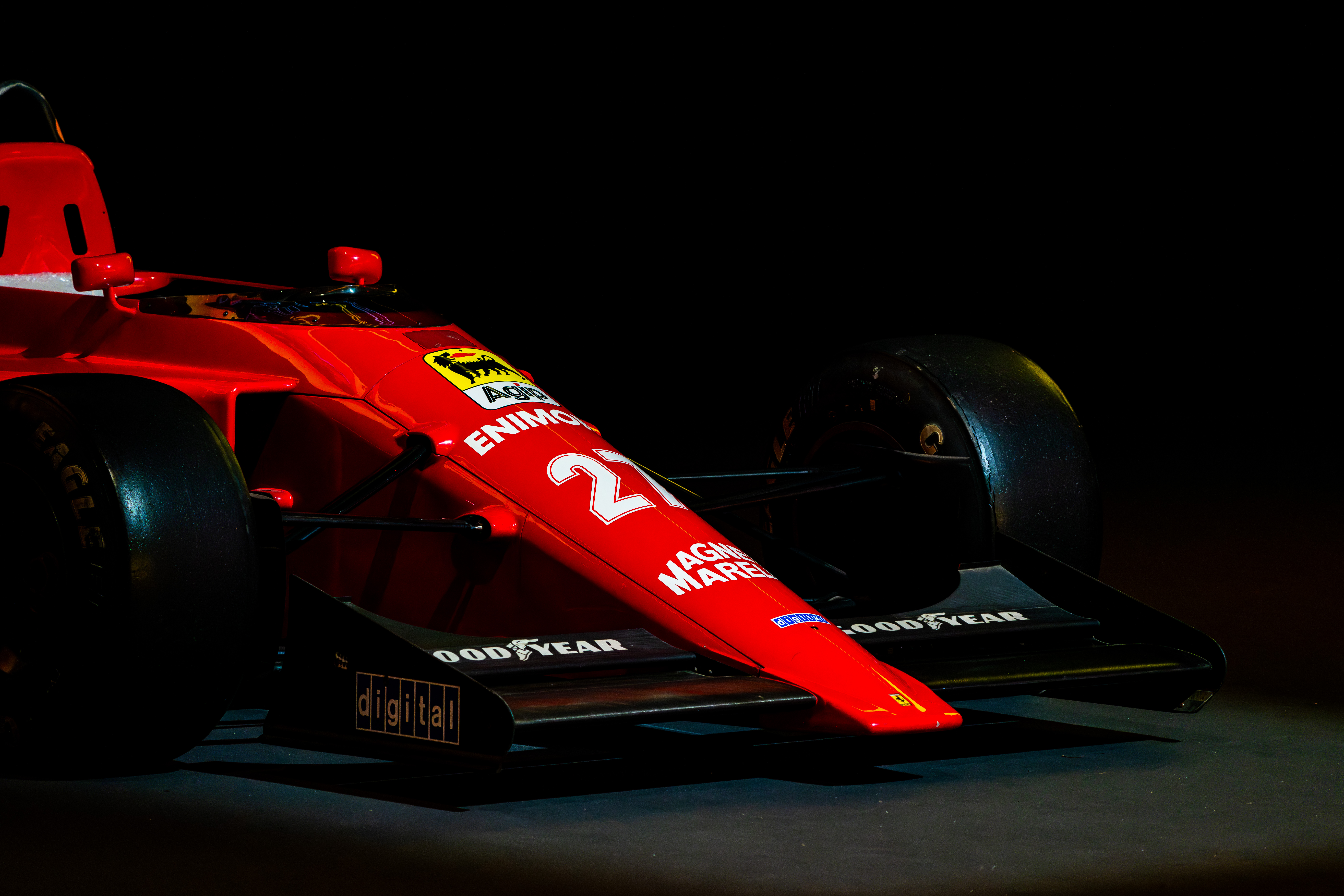 Close-up side view of a historic Ferrari Formula 1 car with visible Goodyear tires and sponsor logos